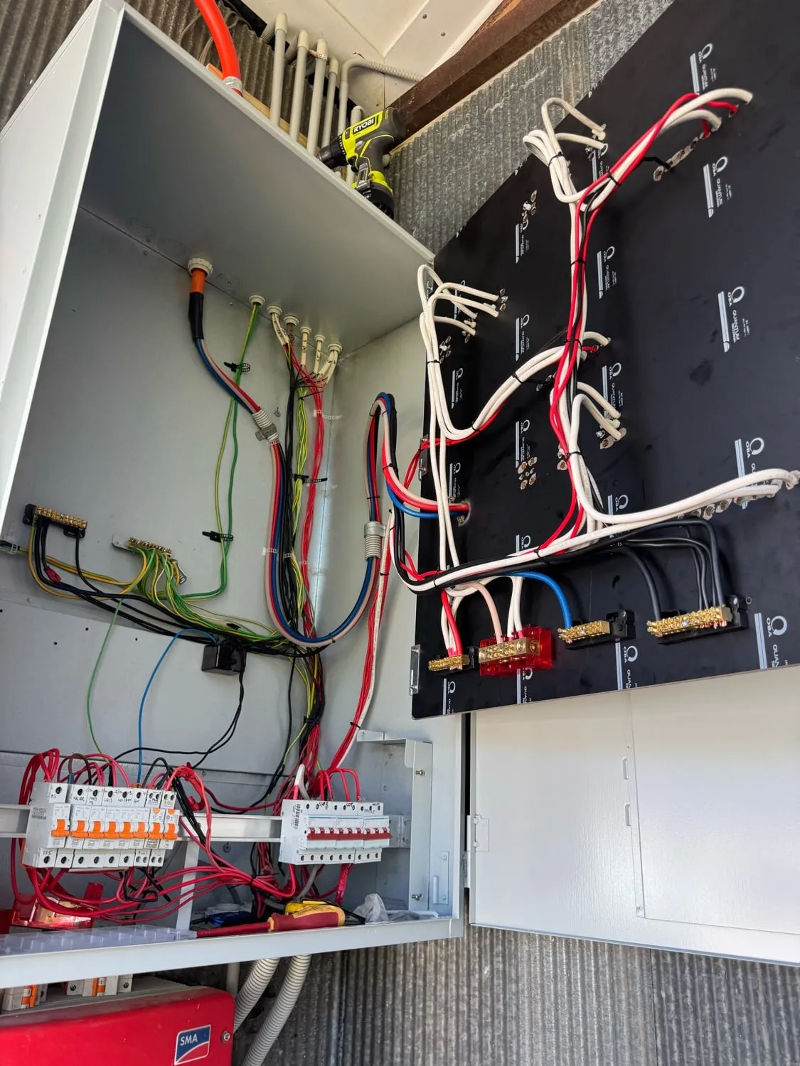 A large new switchboard beside a solar inverter